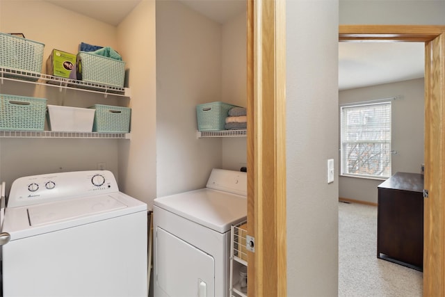 washroom featuring carpet, washing machine and dryer, and laundry area