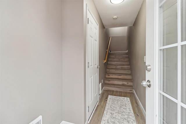 staircase featuring wood finished floors