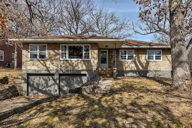 view of front of house with brick siding, an attached garage, and driveway