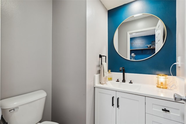 bathroom featuring toilet and vanity