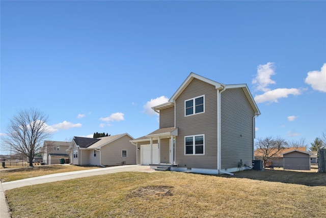 traditional-style house with concrete driveway, an attached garage, a front yard, and central AC