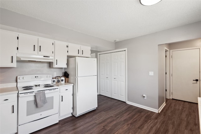 kitchen with under cabinet range hood, white appliances, light countertops, and dark wood-type flooring