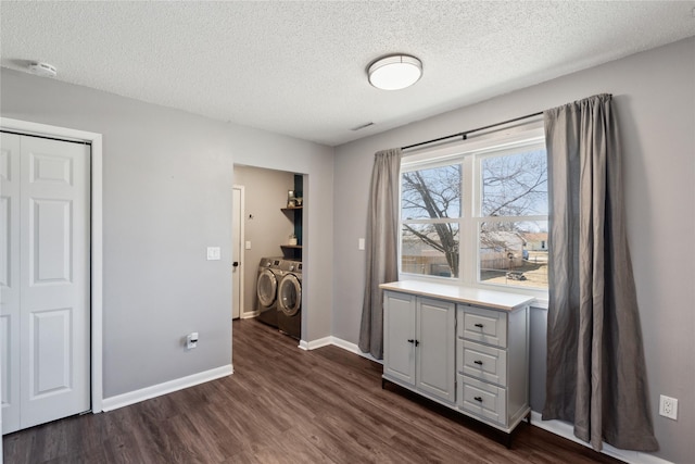 bedroom with independent washer and dryer, a textured ceiling, dark wood-style floors, a closet, and baseboards