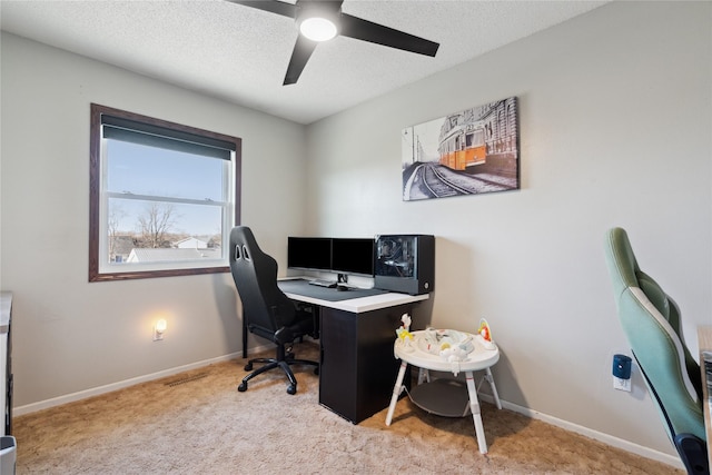 office with baseboards, light carpet, a textured ceiling, and a ceiling fan