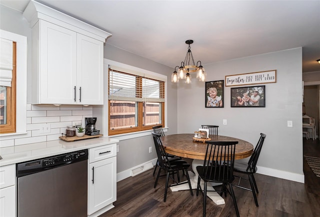 dining area with visible vents, baseboards, dark wood-style floors, and a chandelier