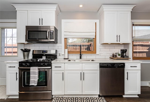 kitchen with a sink, light countertops, and stainless steel appliances