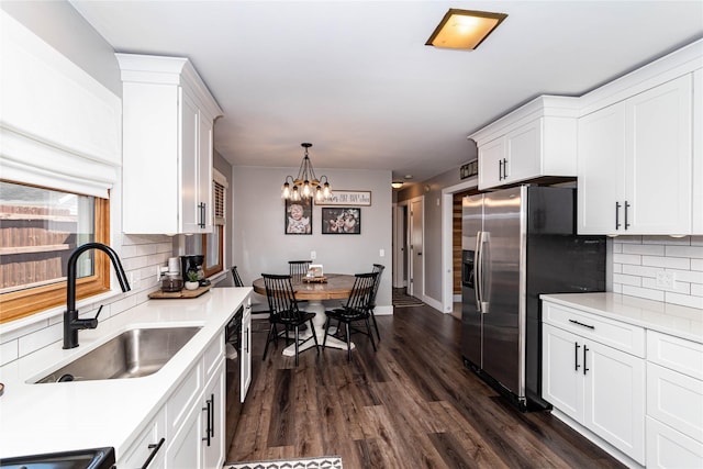 kitchen featuring a sink, dark wood-style flooring, stainless steel fridge with ice dispenser, and white cabinetry