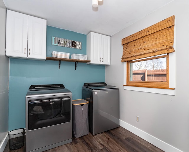 laundry room with baseboards, cabinet space, dark wood-style flooring, and washing machine and clothes dryer