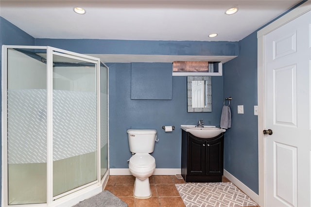 bathroom featuring vanity, baseboards, and a stall shower