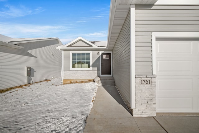 view of property exterior featuring brick siding and a garage