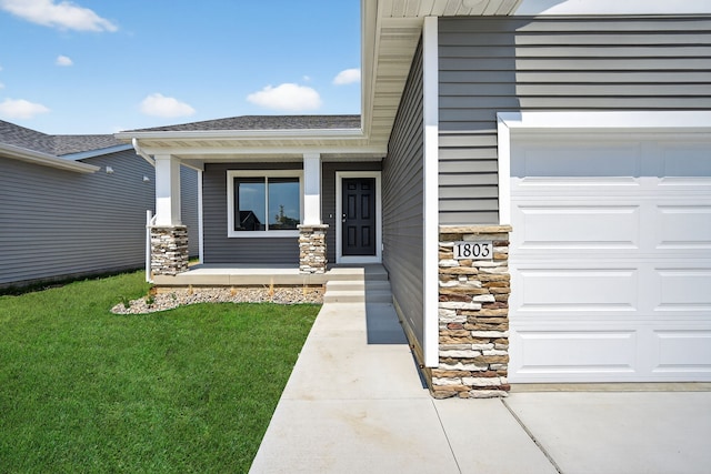 1803 Tuscany Dr SE, Altoona, IA 50009 - property entrance featuring covered porch, an attached garage, a yard, stone siding, and a shingled roof