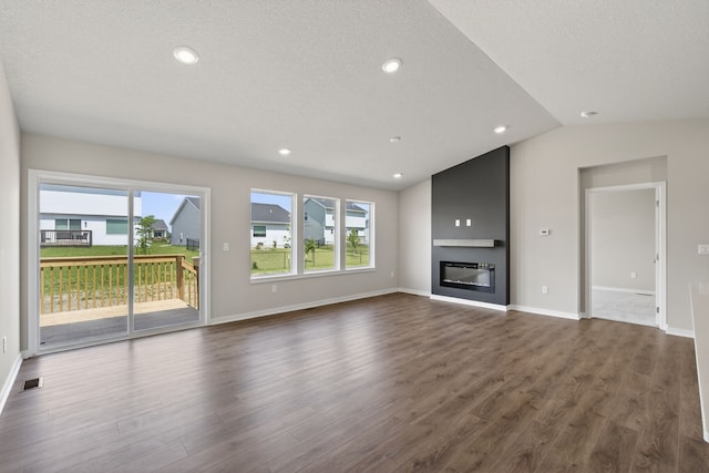 1803 Tuscany Dr SE, Altoona, IA 50009 - unfurnished living room with dark wood finished floors, lofted ceiling, a fireplace, recessed lighting, and a textured ceiling