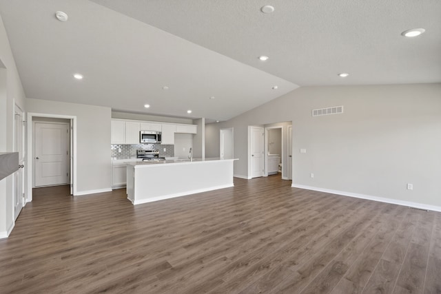 1803 Tuscany Dr SE, Altoona, IA 50009 - unfurnished living room with lofted ceiling, dark wood finished floors, and recessed lighting