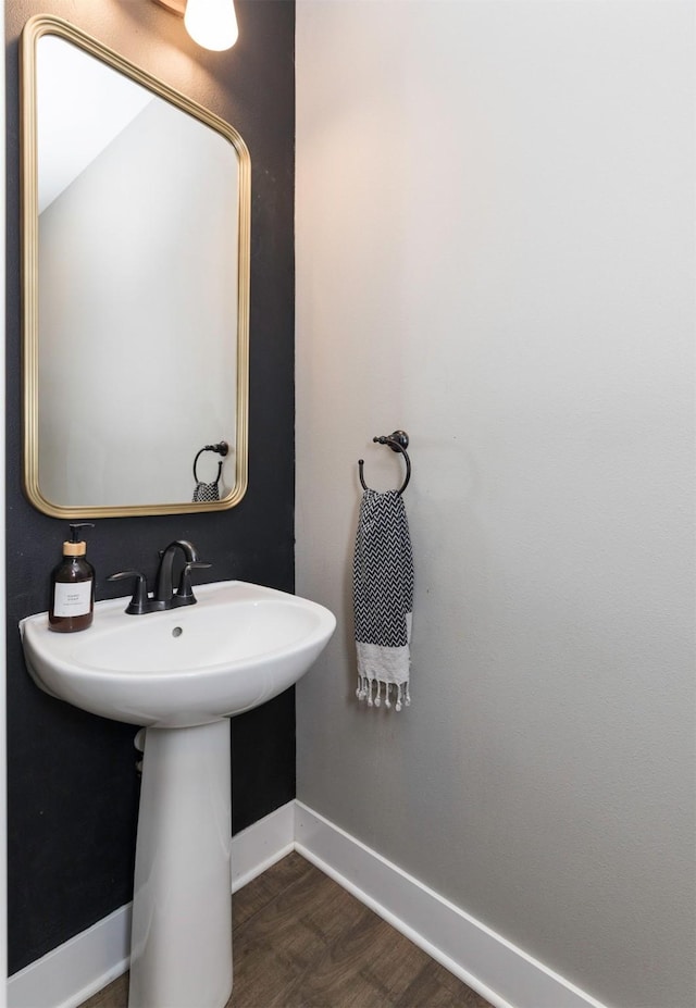 bathroom with baseboards and wood finished floors