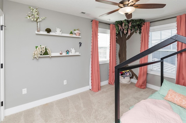 interior space featuring light carpet, visible vents, multiple windows, and baseboards