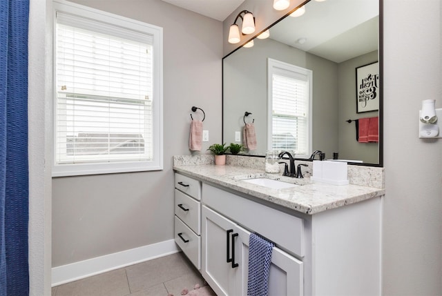 bathroom featuring baseboards, vanity, and tile patterned flooring