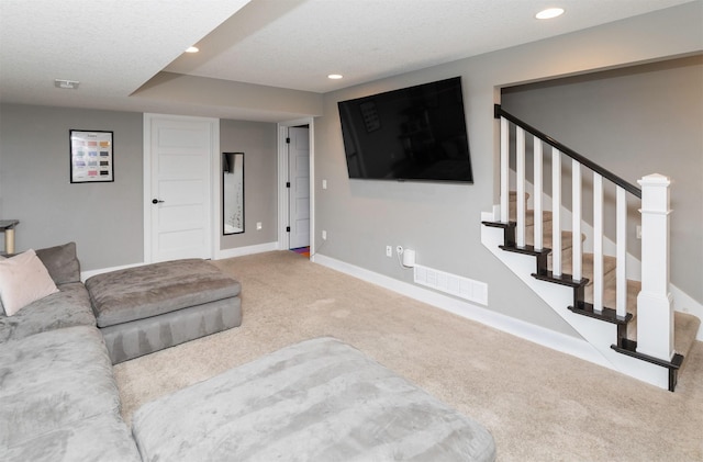 carpeted living area featuring visible vents, recessed lighting, stairway, and baseboards