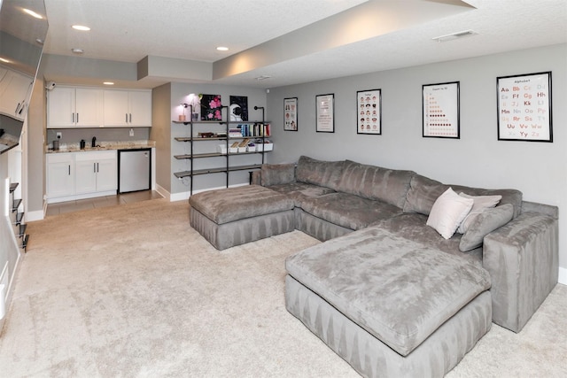 living area featuring wet bar, recessed lighting, light colored carpet, and visible vents