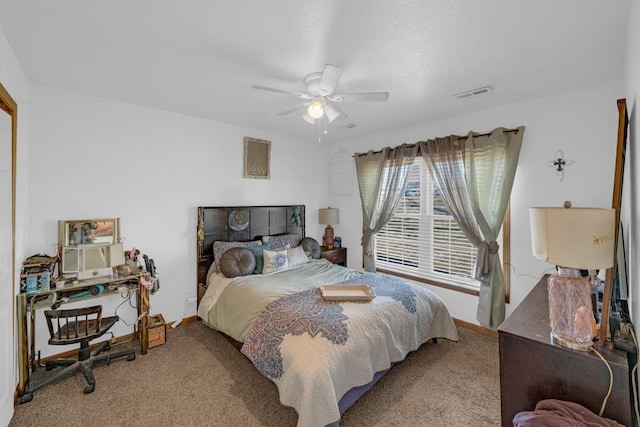 carpeted bedroom with baseboards, visible vents, and ceiling fan