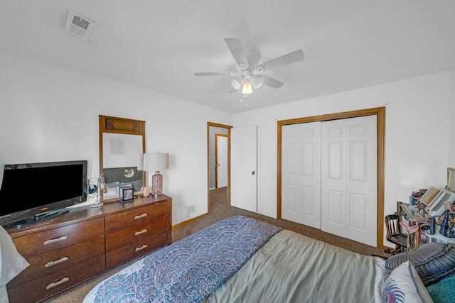 carpeted bedroom featuring visible vents, a closet, and ceiling fan