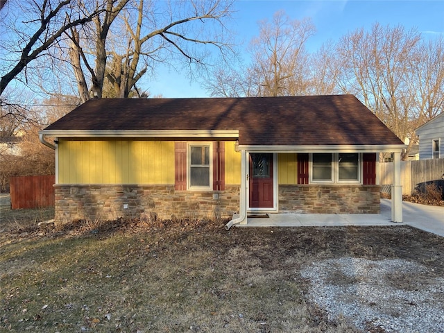 view of front of house featuring fence and stone siding