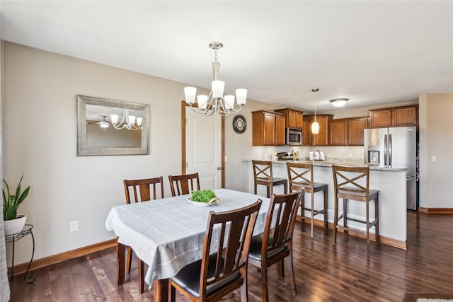 dining room featuring a chandelier, dark wood-type flooring, and baseboards