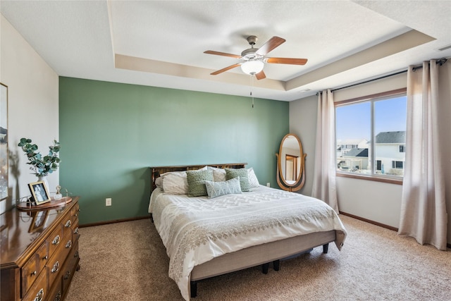 bedroom featuring carpet flooring, a ceiling fan, a raised ceiling, and baseboards