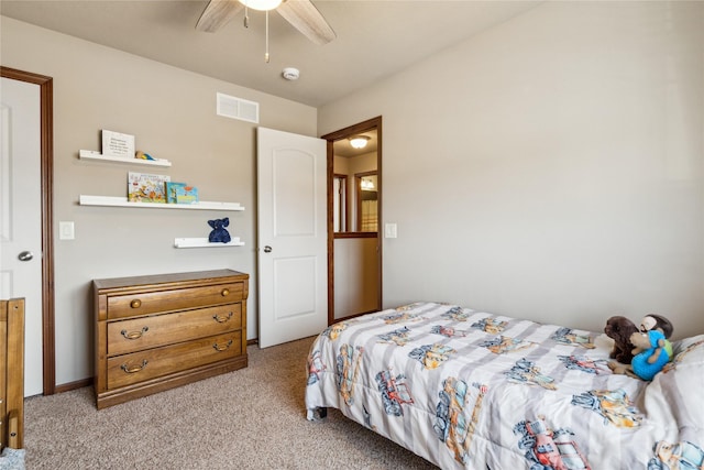 bedroom with visible vents, light colored carpet, and ceiling fan