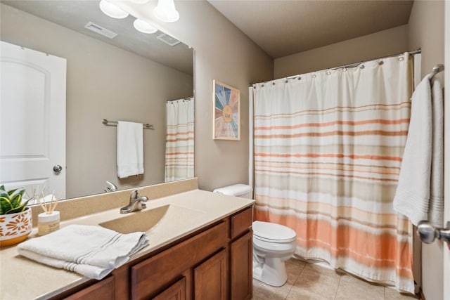 bathroom featuring tile patterned floors, visible vents, toilet, and vanity