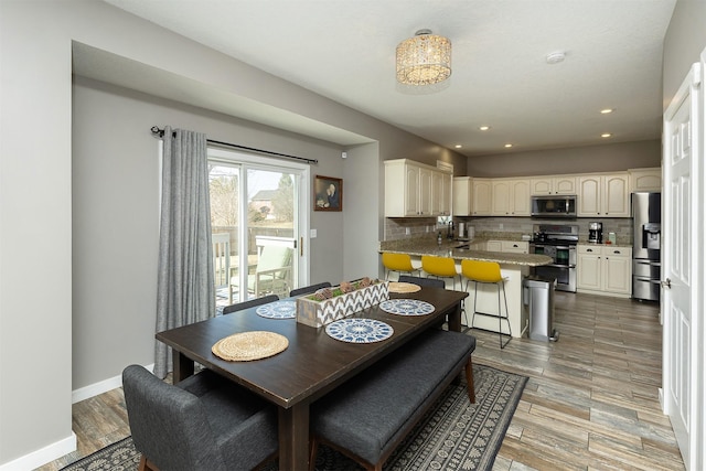 dining area with recessed lighting, light wood-style floors, and baseboards