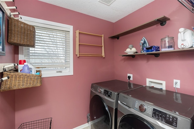 laundry area with washer and dryer, laundry area, visible vents, and a textured ceiling