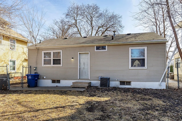 rear view of house with a gate, central AC, and fence