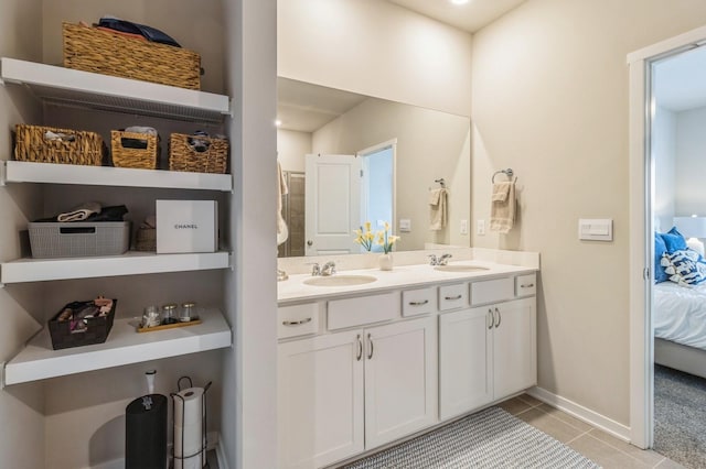 2806 SW Prairie Trail Pkwy, Ankeny, IA 50023 - ensuite bathroom featuring connected bathroom, double vanity, a sink, and tile patterned flooring