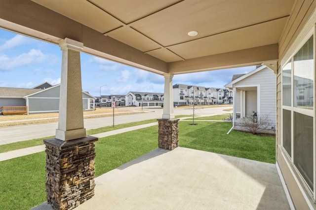 view of patio featuring a residential view and a porch