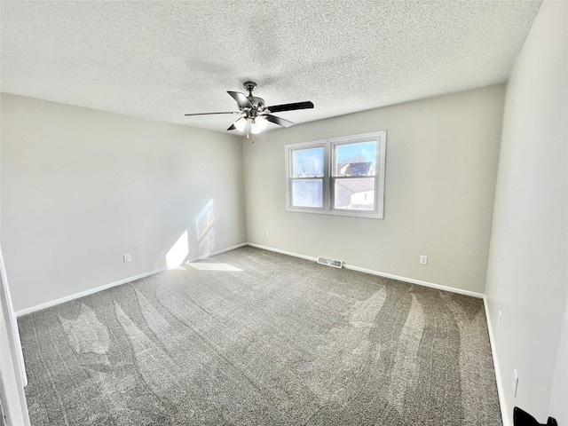 spare room with visible vents, baseboards, carpet, a textured ceiling, and a ceiling fan