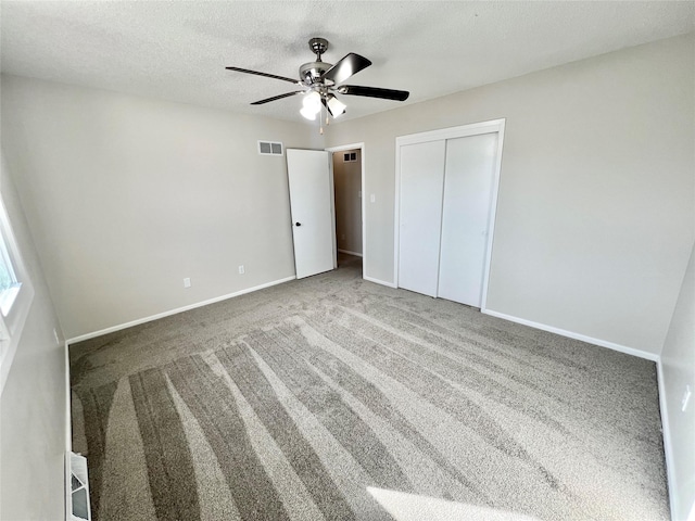 unfurnished bedroom featuring baseboards, visible vents, a closet, and a textured ceiling