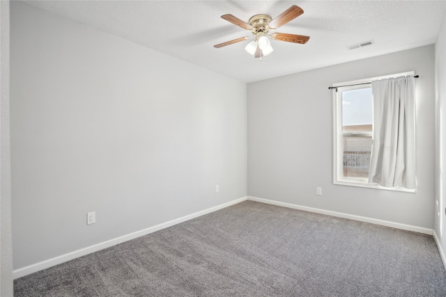 unfurnished room featuring a ceiling fan, carpet flooring, baseboards, and visible vents