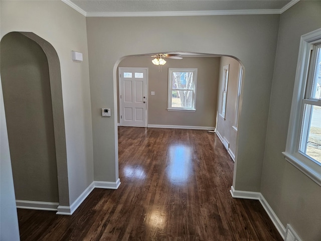 foyer with baseboards, dark wood-type flooring, and ornamental molding