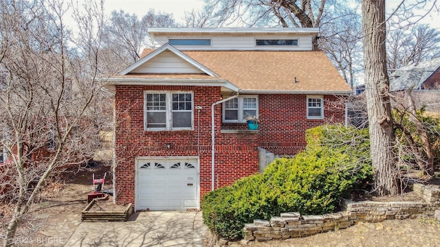 view of front of house with brick siding, concrete driveway, a garage, and a shingled roof