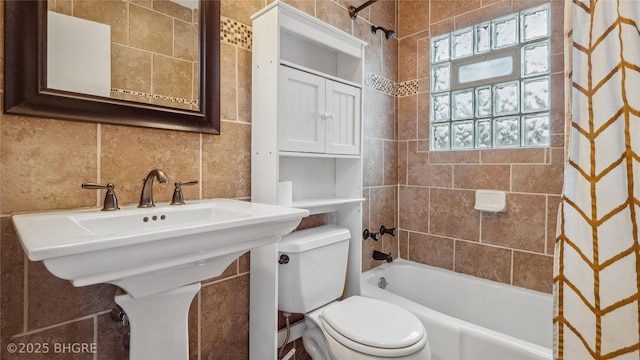 full bathroom with a sink, shower / tub combo, tile walls, toilet, and tasteful backsplash