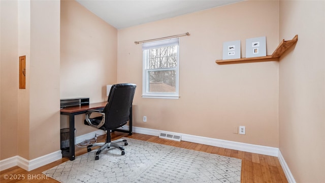 home office with visible vents, baseboards, and wood finished floors