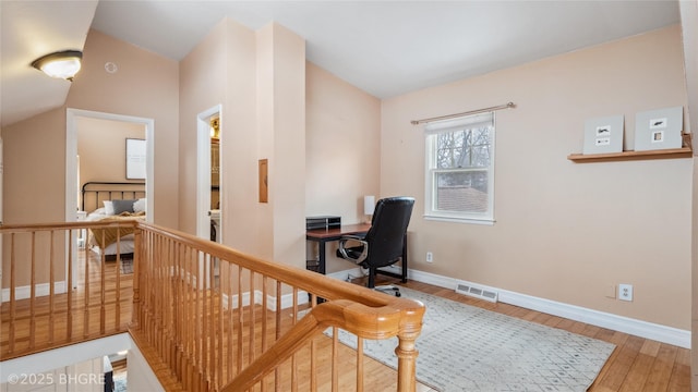 office featuring hardwood / wood-style floors, baseboards, and visible vents