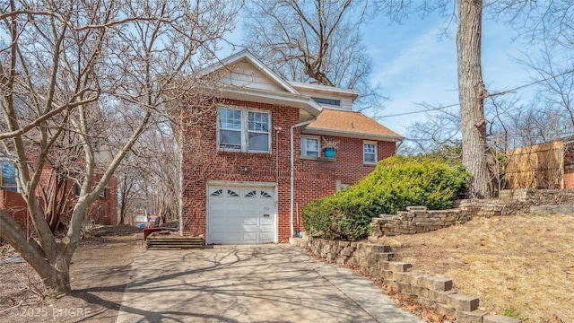 traditional home featuring brick siding, an attached garage, concrete driveway, and a shingled roof