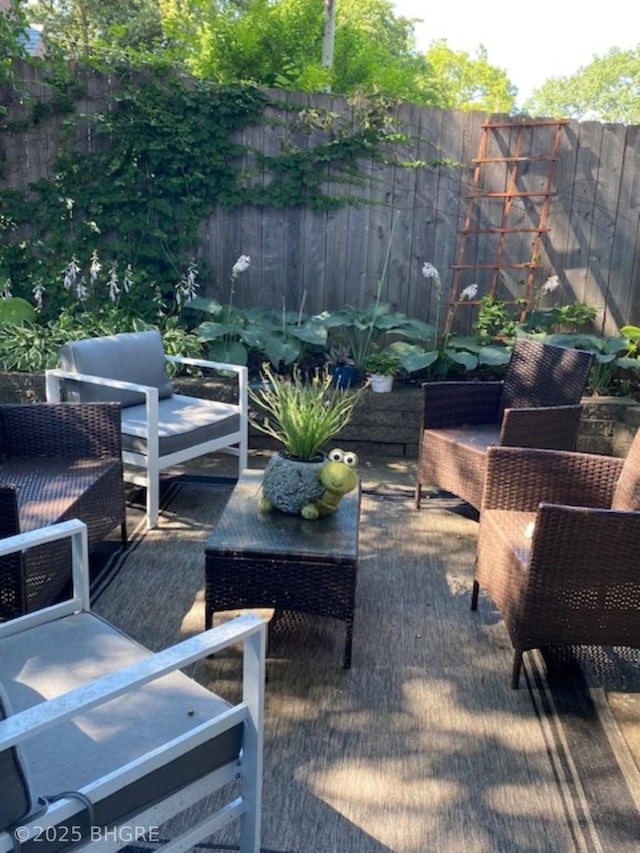 view of patio featuring an outdoor hangout area and a fenced backyard