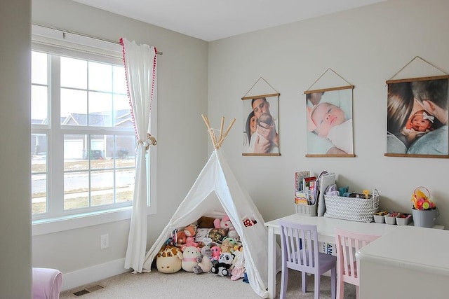 bedroom with a nursery area, baseboards, visible vents, and carpet floors