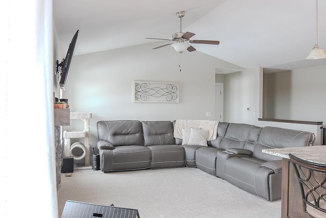 living area featuring lofted ceiling, carpet flooring, and ceiling fan