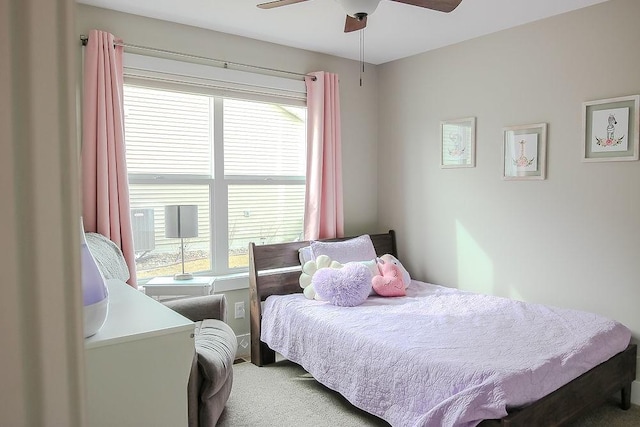 bedroom with multiple windows, light colored carpet, and ceiling fan