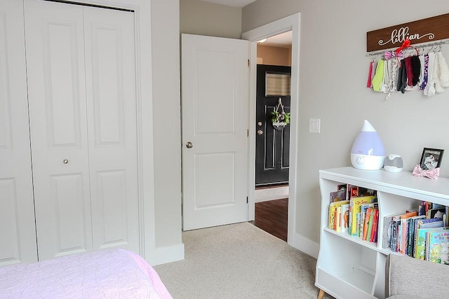 bedroom with a closet, baseboards, and carpet flooring