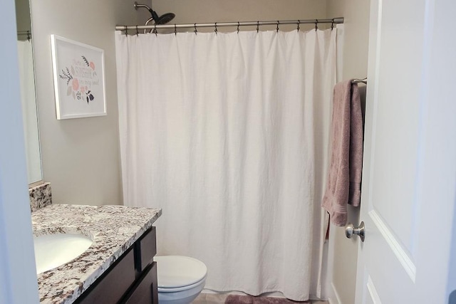 bathroom featuring toilet and vanity