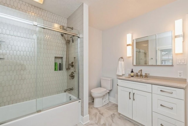 bathroom featuring toilet, marble finish floor, shower / bath combination with glass door, baseboards, and vanity